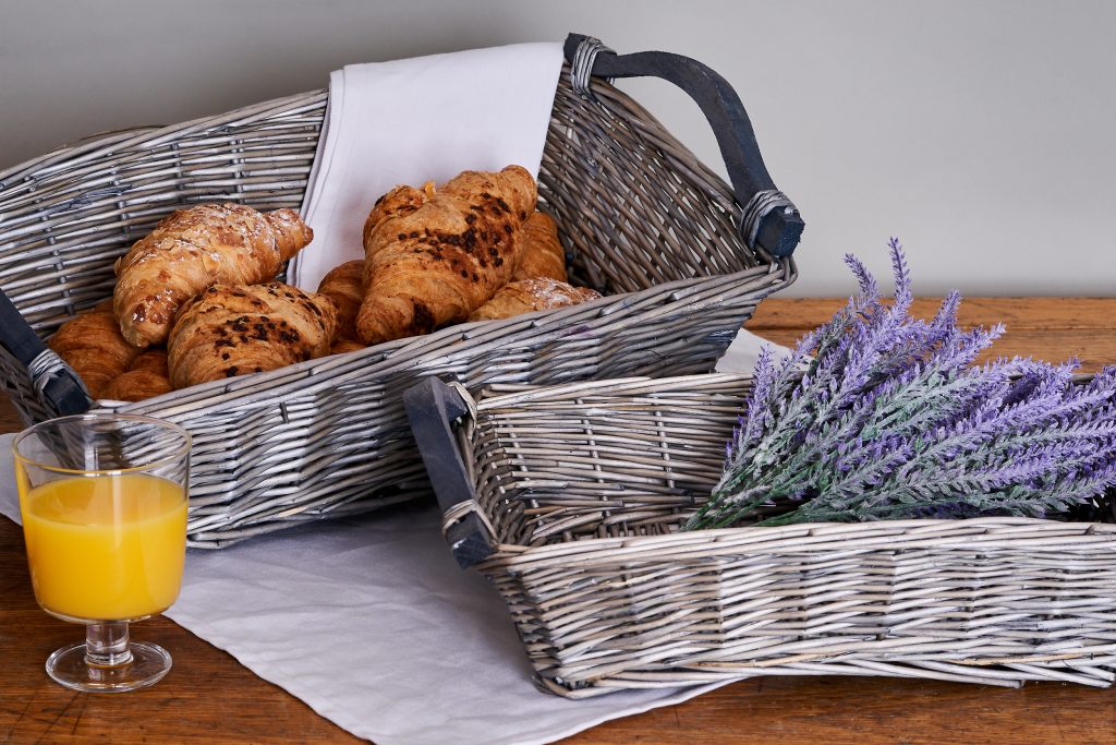 Sheffield product photography Timm Cleasby two wicker baskets with croissants and heather in them and a glass of orange juice