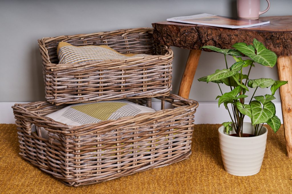 product photography Sheffield two baskets with blankets in them, a plant pot and a wooden coffee table on a mustard rug